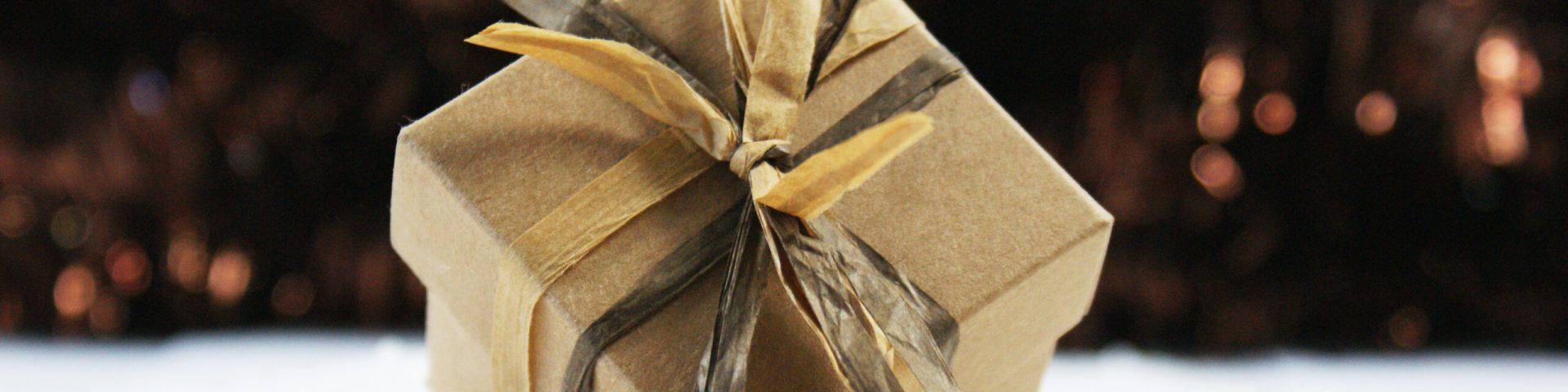 Shabby chic Christmas gift nestled in snow